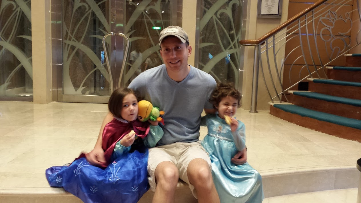 Zoe dressed as Elsa and Kyrie dressed as Anna before watching Frozen aboard Disney Cruise Line.