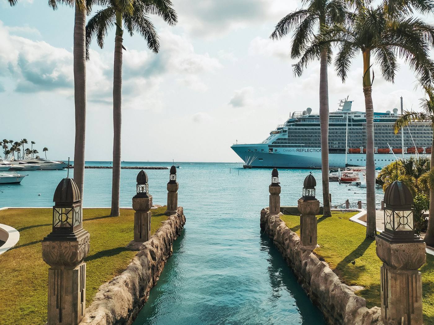 Celebrity Reflection cruise ship in a Caribbean port with palm trees