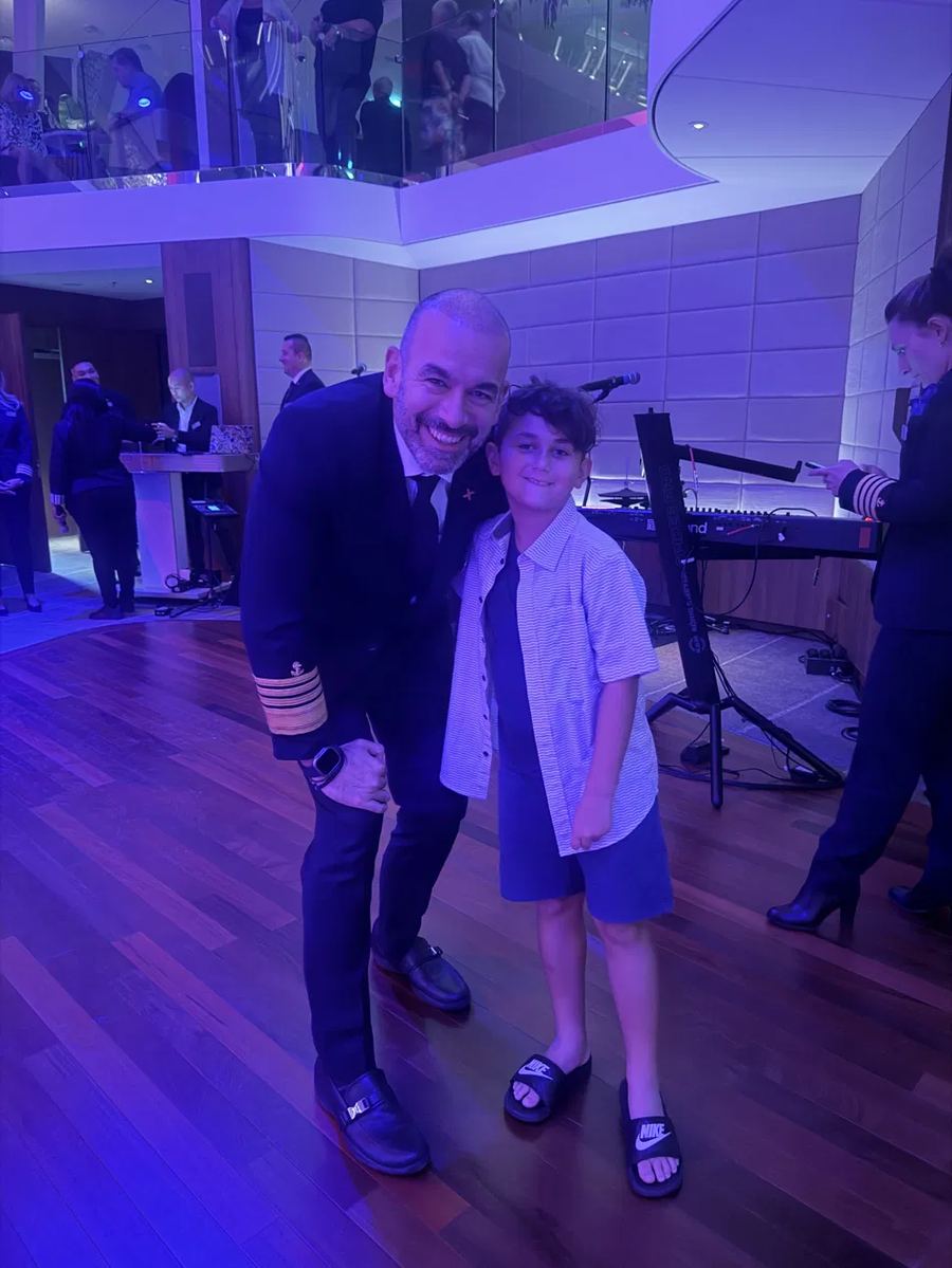 Lincoln posing with the ship's captain at a special event aboard a Celebrity cruise.